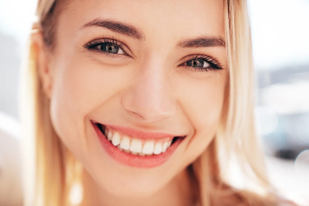 Close-up of a woman with a bright, healthy smile